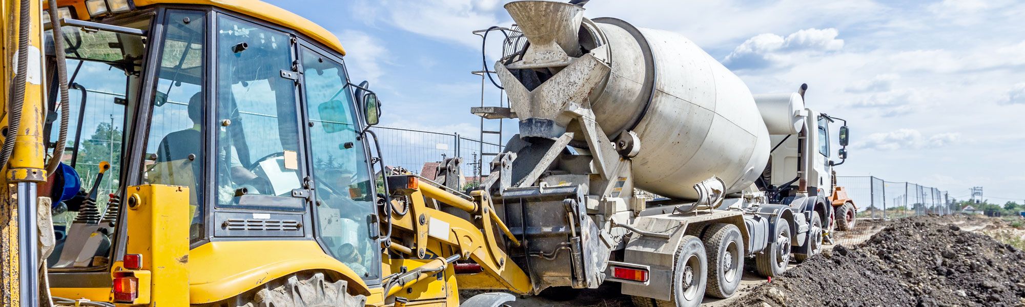 Concrete mixer and JCB on building site in Wrexham